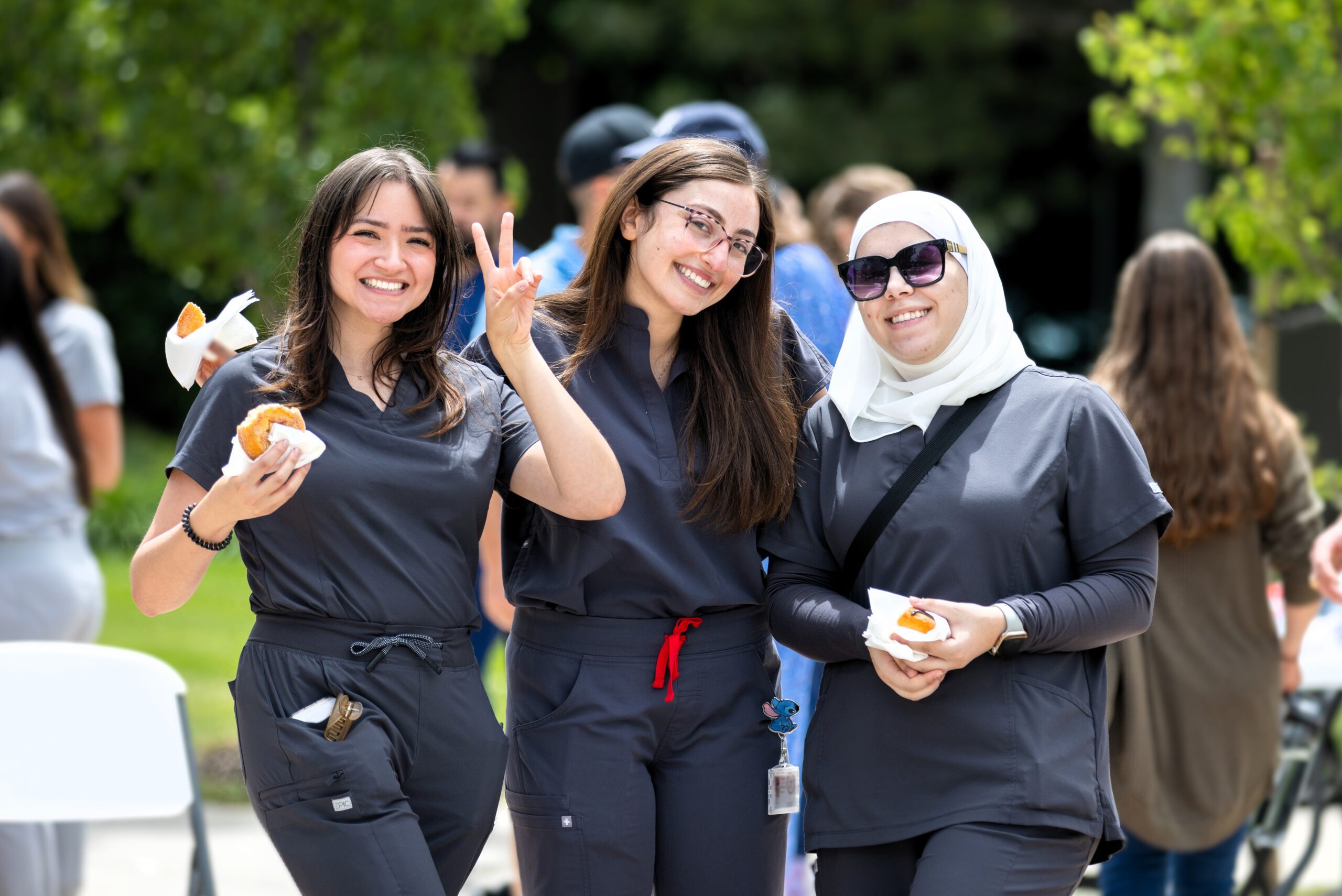 Three students pose for photo at a university event