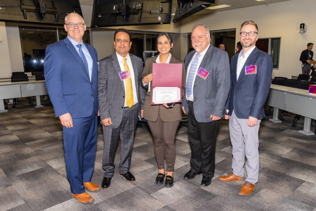 Student winning award at Roseman's 11th Annual Research Symposium