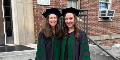 Dr. Kimberly Veltman poses with a friend after earning her medical degree.