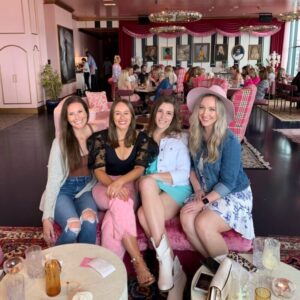 Dr. Kimberly Veltman and friends smile for a group photo at White Limozeen, and all-pink rooftop eatery, in Nashville, Tennessee.