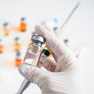 hand holding vaccine