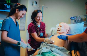 nursing students practicing on a mannequin