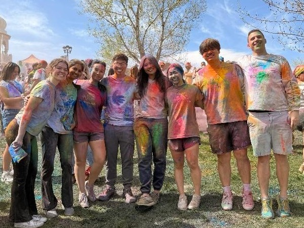Students gather for a group photo at the Festival of Colors at the the Sri Sri Radha Krishna Temple