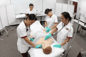 Nursing students working with a manikin in a simulation lab at Roseman University